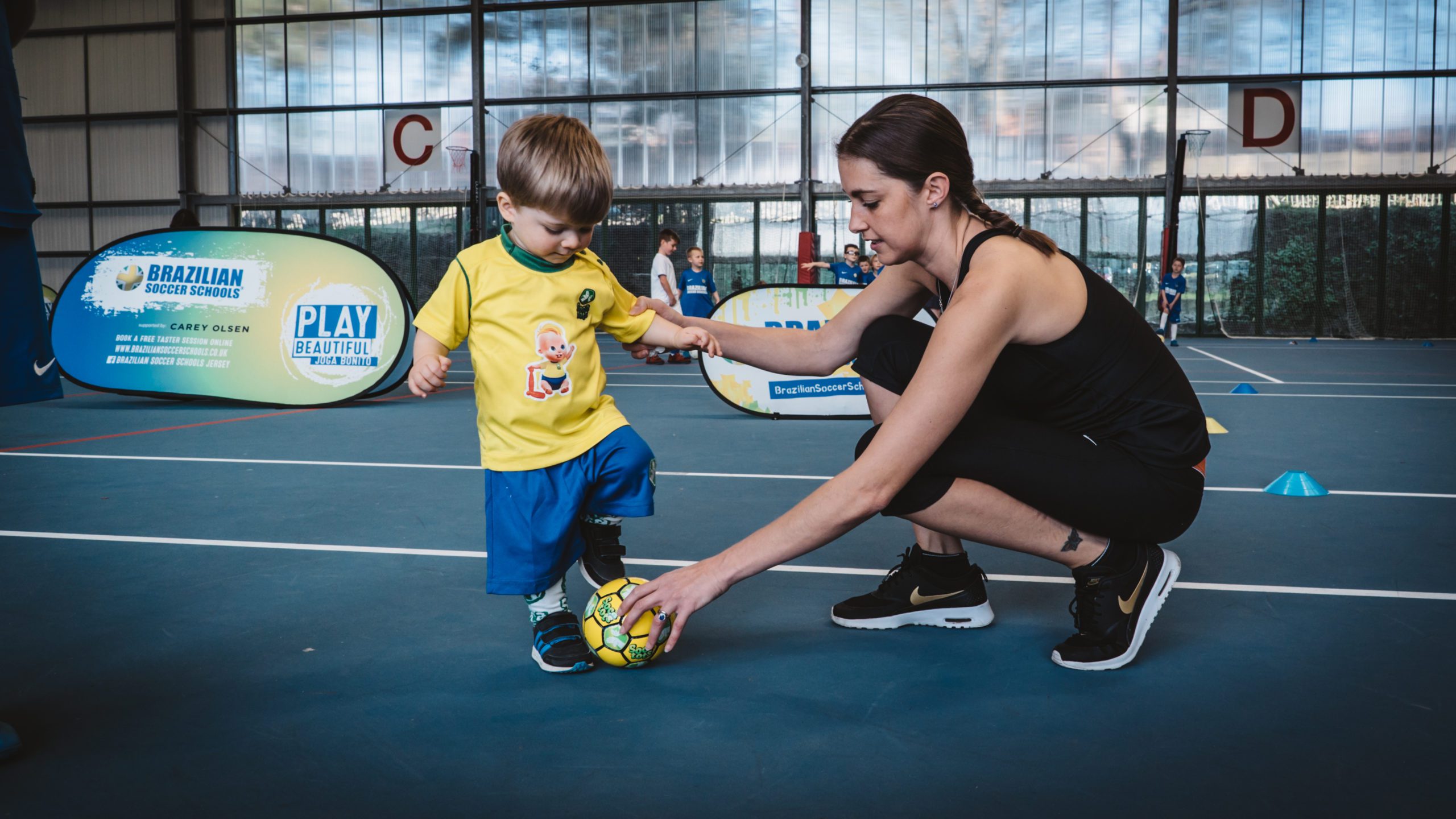 SOCATOTS coach with child in sports hall