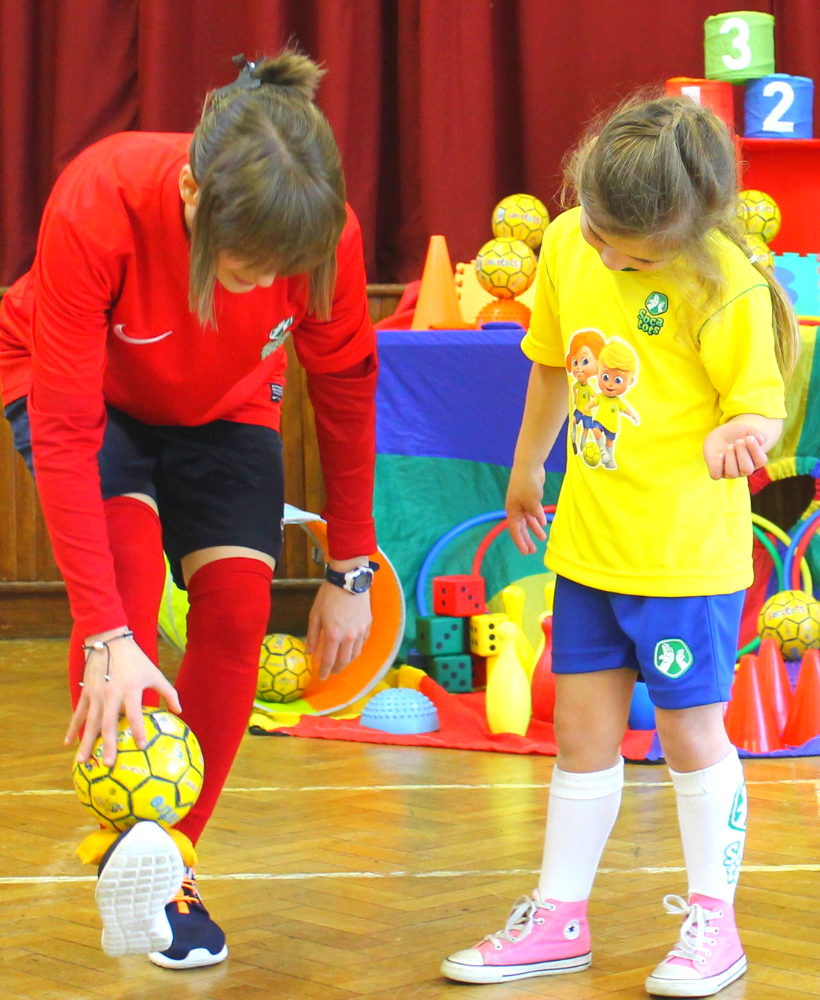 SOCATOTS coach with child in sports hall